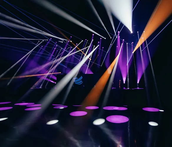 Professional moving head lighting fixtures illuminating a concert stage
